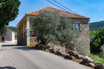 the building behind the olive-tree is your destination.