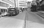 Ein Trammotorwagen der Serie Be 2/2 der Linie 7 auf dem Wartegleis und ein Bus Linie 36 in der Spiegelgasse die Haltestelle Schifflände anfahrend, 1969
