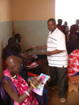 SMECAO staff distributing IEC material during local campagn on World AIDS Day 2011 in Kalamba