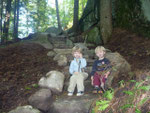 Levi and Thad rest on the stairs during a hike to the water