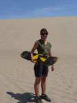 Sandboarding on the sanddunes in the desert