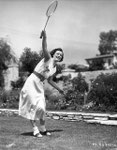1934 - promo shot playing badminton on the court of her Hollywood home