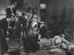 on set - the kneeling man is director John Cromwell