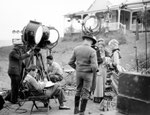 with director William Wellman(sitting), Henry Stephenson and Mary Boland on the set of Stingaree