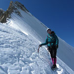 Alex on the ridge with a tough Ordinary Route and the North Face behind.