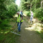 Raking cut grass from the edge of the ride at the west end of the wood.  A tidy up exercise with much chatter and laughs.