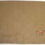 Witziges Hundegesicht gestickt auf beige Fleecedecke