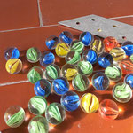 "Piccola storia del mondo", 2024, glass marbles, galvanized metal, slope, 1 x30 x20 cm, detail