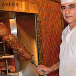 Mister Afonso shows a huge meat skewer in the Churrascaria Rafain