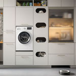 Eleganter Hauswirtschaftsraum mit Einbauschränken, integrierter Waschmaschine, offenen Fächern für Wäsche und Reinigungsmittel sowie begehbarem Kleiderschrank.