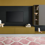 Design-TV-Möbel in Senfgelb und Grau mit Wandboard und offenen Regalen, stilvolle Wohnwand für das Wohnzimmer mit modernem Teppich.