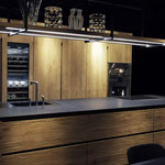 Cuisine en bois et laque noire. Plans de travail en pierre noire. Cuisine avec ilot central. Cuisine ouverte. Cuisine tendance. Cuisine sans poignée. Cuisine moderne et tendance 2023. Cuisine haut de gamme. Cuisin Design Toulouse