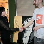 Enya signing a painting for the World Music Awards charity, London, 2006