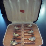 Dark brown bakelite cutlery box with plated coffee spoons