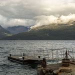 Die Sonne trifft auf die Berge auf dem Gegenufer