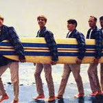 5 beach boys and 1 surfboard