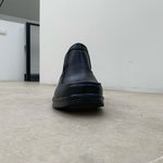 Secondo piano: Luca Scarabelli, "Intervallo", 2019, scarpa nera con buco, ph. LATO