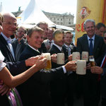 Politische und wirtschaftliche Prominenz trinkt auf das Fest.