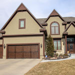 The Dark Walnut Garage Door Faux really Compliments the Front of this Olathe Home