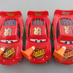 From left to right: Lightning McQueen w/cone (V1) - Lightning McQueen w/cone Puzzle box variant Unibody (V2) - Lightning McQueen w/cone (V3)