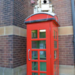 a phone box with birdhouses on the top