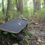 Jamaad's longboard and phone on a nature walk after boarding