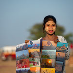 Young woman sells souvenirs to tourist doing a balloon ride, Myanmar © Stephan Stamm