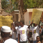 Secondary School students holding signs at inauguration ceremony for 16 day´s campaign against gender violence in Kihurio