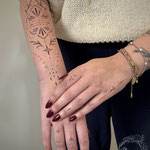 fineline ornamental lowerarm finger tattoo