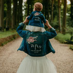 bruid en bruidsmeisje in gedecoreerde spijkerjasjes van aim your wedding