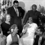 Marion is seated on Baba's left