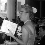 Marion making announcements at Longchamps Restaurant, New York.