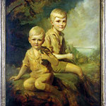 Portrait of two young boys seated in a verdant landscape