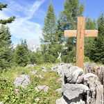 ... sowie dem kleinen hölzernen Gipfelkreuz mit Aussicht auf die Spitzmauer in der einen...
