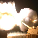 Eine M109 feuert bei Nacht.