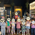 a group of kids with panda masks covering their faces