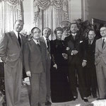 on the set of Life With Father with Michael Curtiz (left), Jack Warner (third from left) and other unknown visitors