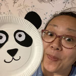 Woman holding a panda made from paper plate