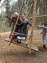 Traditional Easter swing with a man and a woman in folk costume at the Latvian Open Air Ethnographic Museum