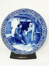 A Dutch Delft Porceleyne Fles wall plate after Petrus van der Velden (1837-1915)