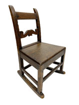 An 18th century English oak children's rocking chair