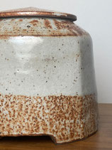 shino jar with hand-carved foot