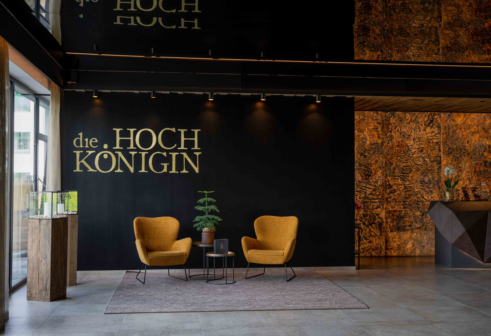Modern hotel lobby with a seating area at the Hochkönigin Wellness Hotel in Maria Alm, Salzburg _fullwidth-story-splash 