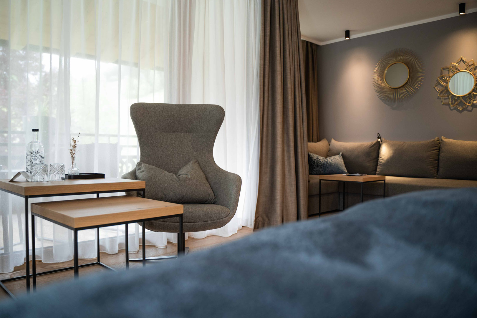 A modern room with a seating area at the Hochkönigin Wellness Hotel in Maria Alm, Salzburg