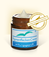 Produktabbildung: „Pigmentflecken Creme“ im Braunglastiegel 30 ml, geöffnet, Beschriftung „wirkungsgeprüft“. Mit „Siegel – Wirksamkeit und Verträglichkeit dermatologisch geprüft“.