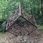 Paolo Grassi – Cube 77, open iron cube filled with abstract numeric structures, outdoor installation.