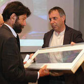 Institutional award ceremony in Venice with Paolo Grassi and Massimo Cacciari, featuring a framed numerical artwork.