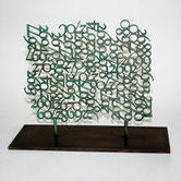 Paolo Grassi – Raster Two, bronze sculpture of a dense grid formed by floating numbers on black base.