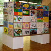 Collective artwork by Paolo Grassi at OSC Mendrisio, created from hand-painted square panels by residents.
