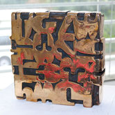 Bronze sculpture by Paolo Grassi titled Box, a conceptual cube composed of sequential numbers, derived from a series of abstract paintings.